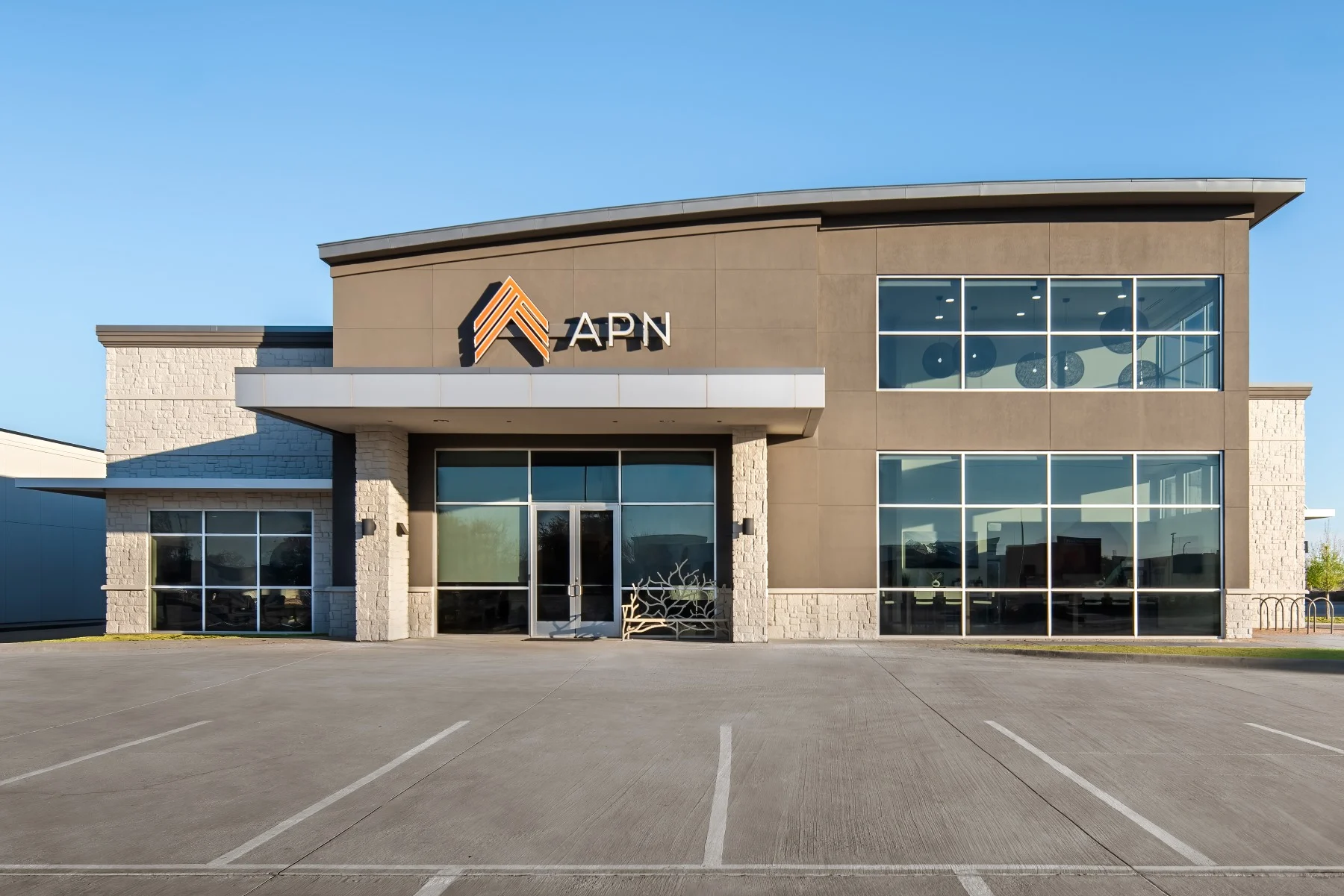 APN DFW rehabilitation center exterior view showcasing modern architecture and prominent APN logo, emphasizing a welcoming environment for addiction treatment and mental health care.