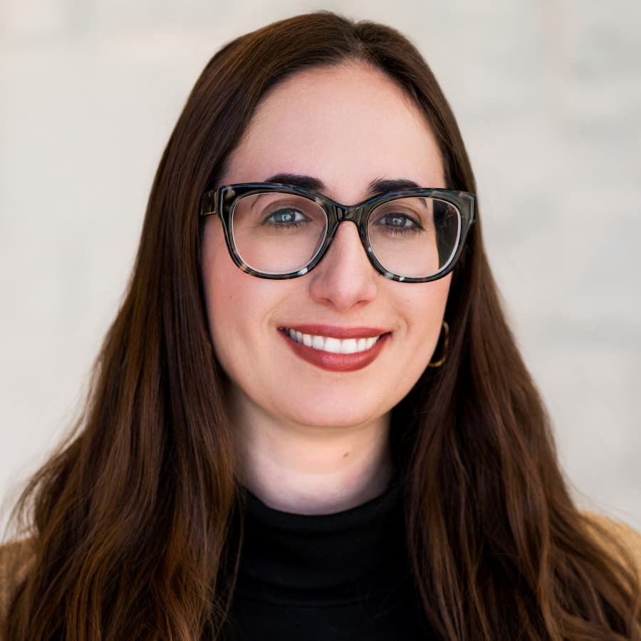 Alexandra Frascino, MS, LMFT-S, Clinical Director at All Points North DFW, smiling with long brown hair and glasses, against a light background.