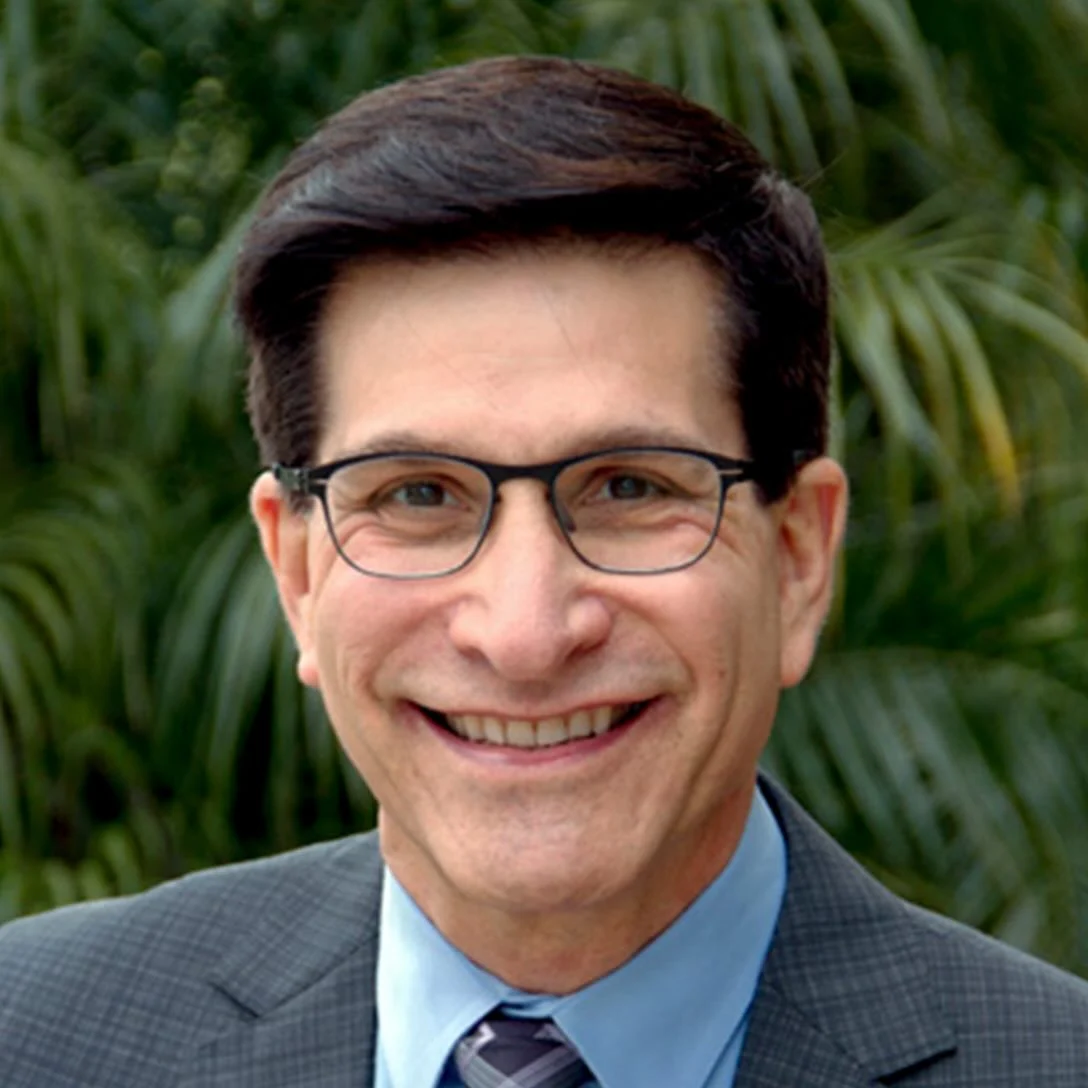 Dr. David Sack, MD, smiling portrait, Medical Director at All Points North DFW, set against a green background.